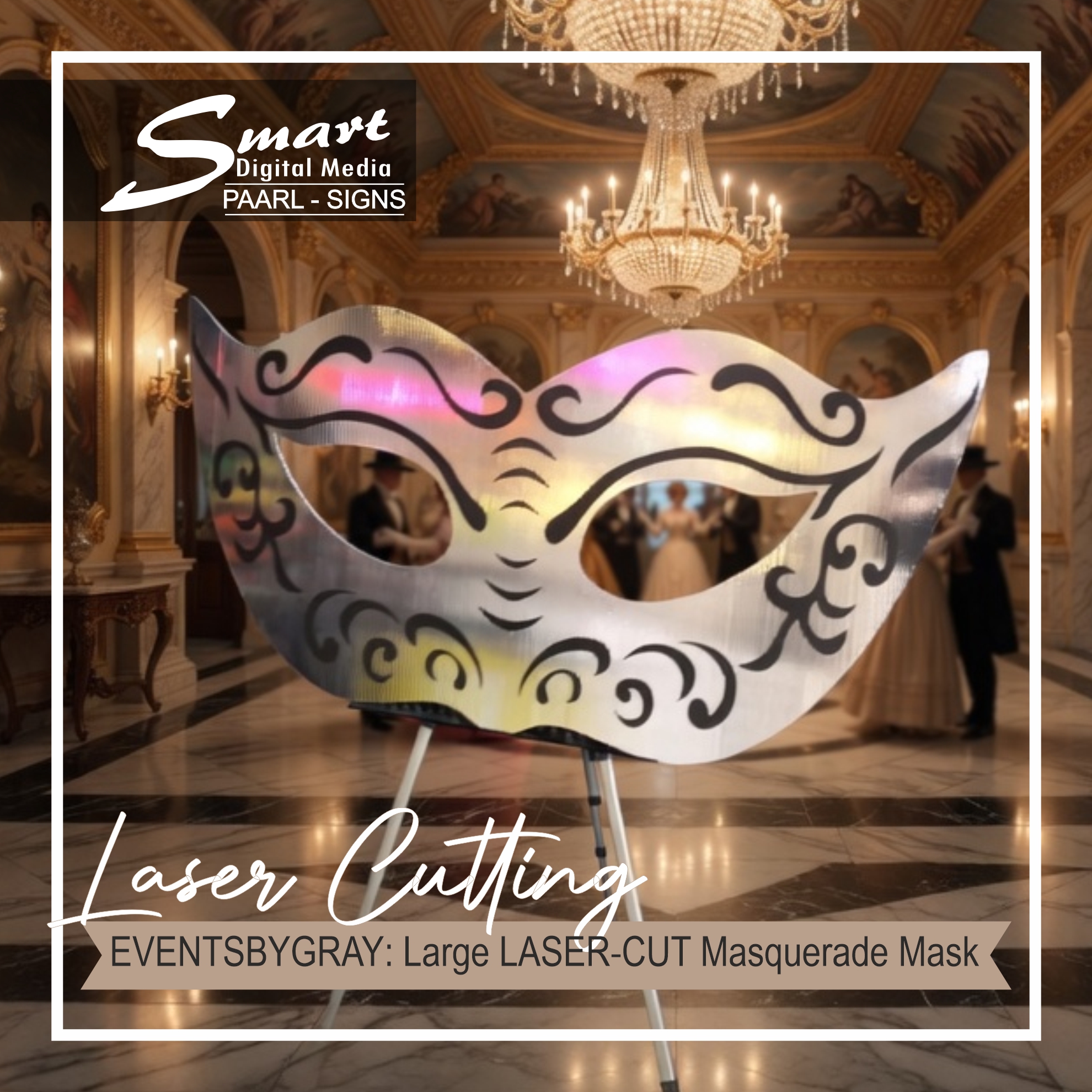 Large ornate laser-cut metal masquerade mask on tripod displayed in a luxurious ballroom with chandeliers for EventsByGray by Smart Digital Media Paarl