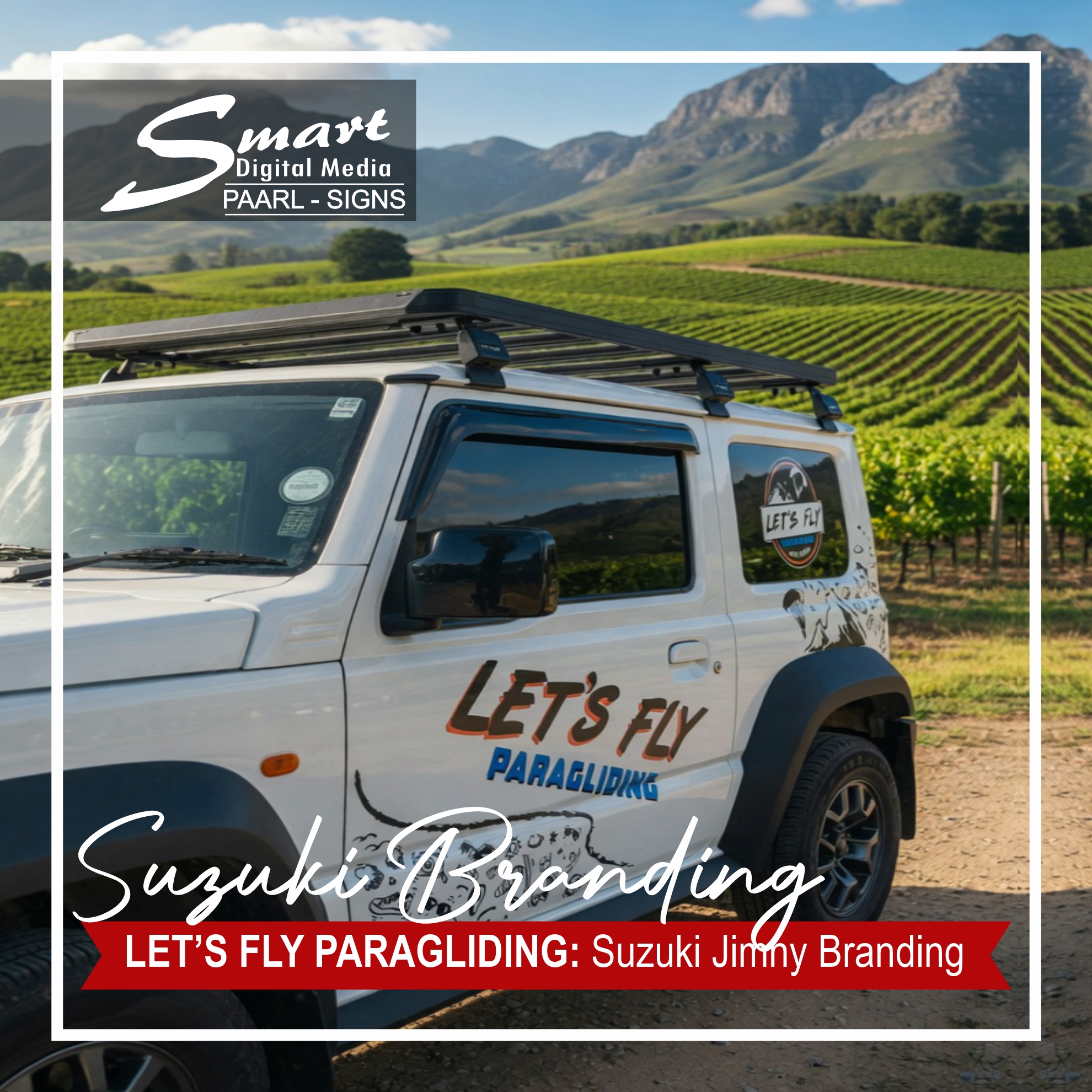 White Suzuki Jimny with professional vinyl branding for Let's Fly Paragliding by Smart Digital Media Paarl. The vehicle features bold adventure graphics with mountains and parachutes, parked in the scenic Cape Winelands vineyards, showcasing high-quality vehicle signage.