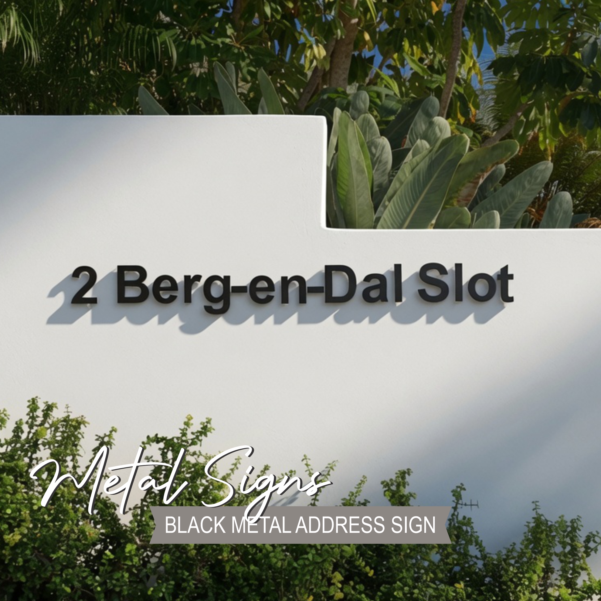 Modern black steel address sign "Berg-en-Dal Slot" installed on a white boundary wall in a beautiful Paarl property. Luxury street and home metal signage surrounded by lush gardens and palm trees